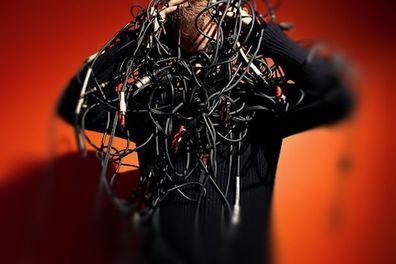Picture of man holding a mess of tangled cables.